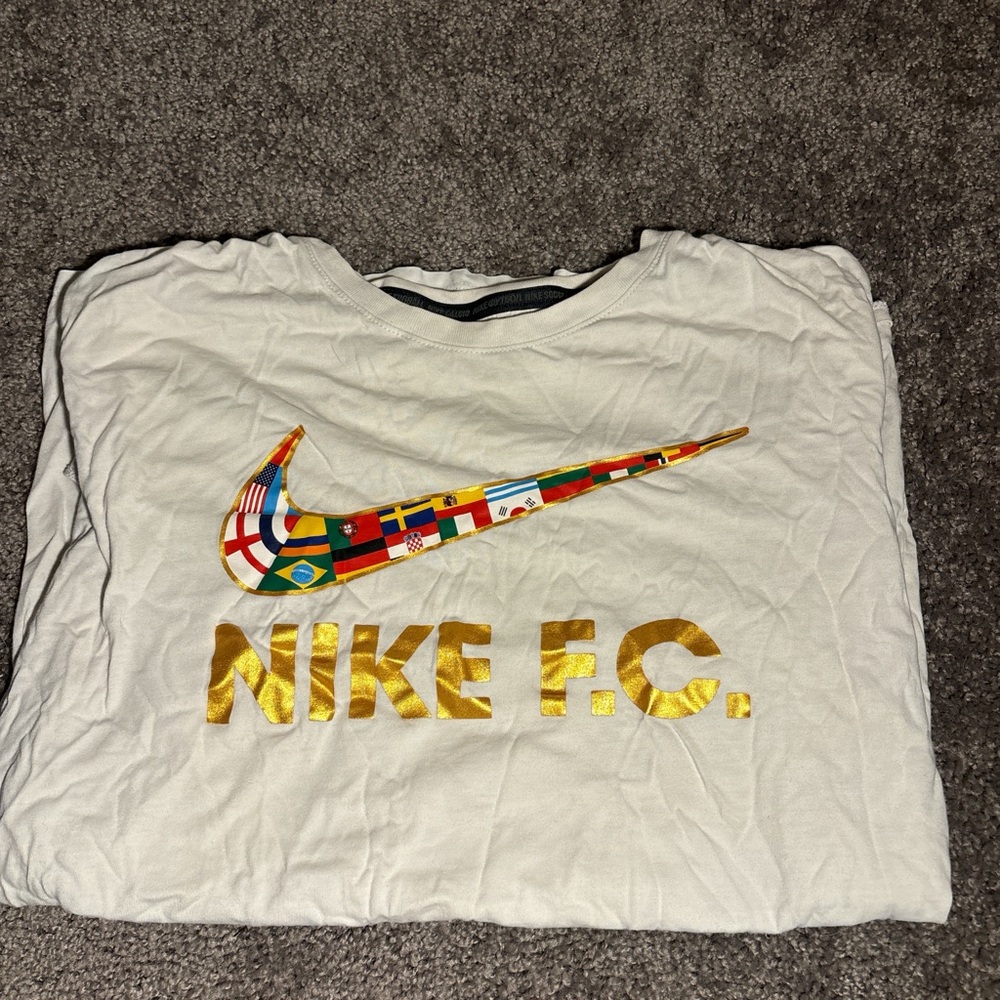 Nike F.C. White Tee with Flag Swoosh and Gold Lettering